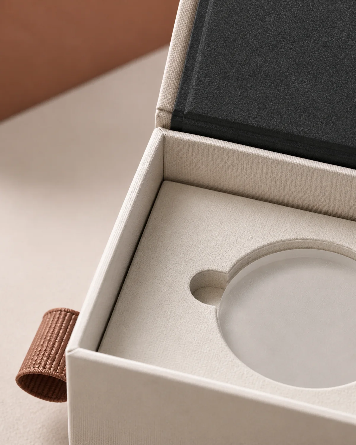 Material study of a fitted box insert, wrapped corner and clay textile pull tab.